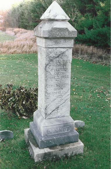 Gravestone with text: J.H. Damkot born Oct. 19 1819 Died June 2 1896. Janna H. Damkot born March 10 1813 (?) Died June (?) 1898