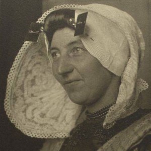 Woman wearning a traditional hat with ear irons