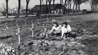 Dutch girls laying flowers on the graves of a temporary graveyard for killed Canadian soldiers. Edderwolde, The Netherlands, 1945.