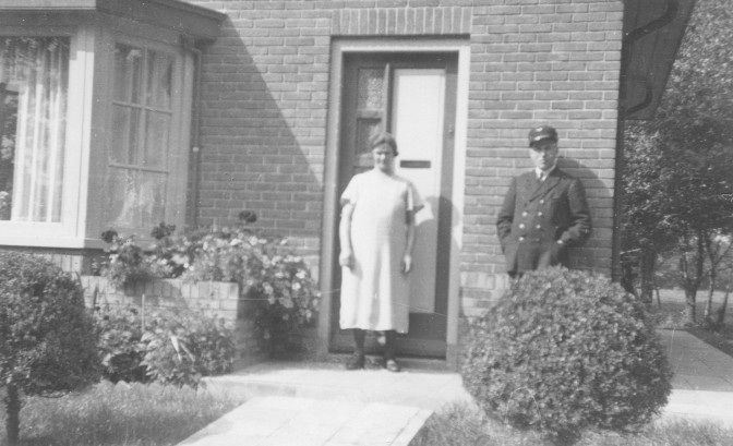 Couple standing in front of a house