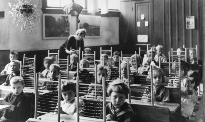 Children in a classroom with counting frames