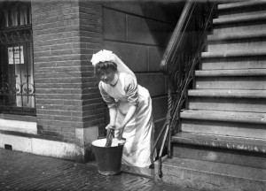 maid scrubbing the pavement