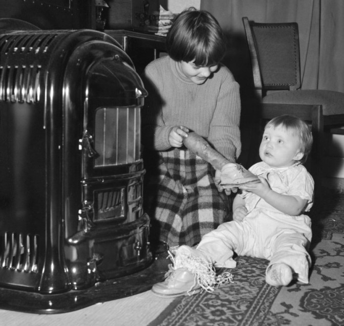 Children putting shoes by the fireplace