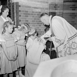 priest baptizing a child