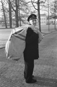 Mail man carrying a full mail bag