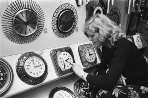 women setting time on a clock