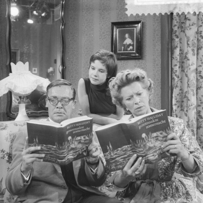 people reading a book, looking surprised