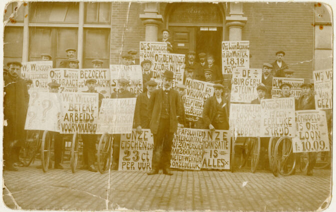 photo of men with signs protesting low wages
